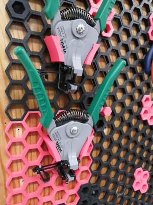 Wire stripper holder for honeycomb storage wall