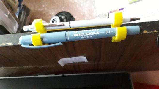 mount for pencil and pen on the end of the shelf