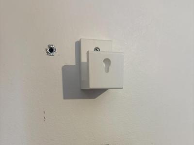Removable hockey stick logo wall mount