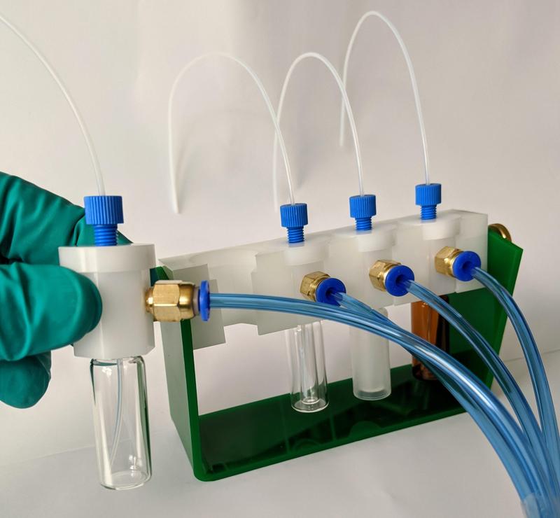 Modular pressure vial holder with manifold caps