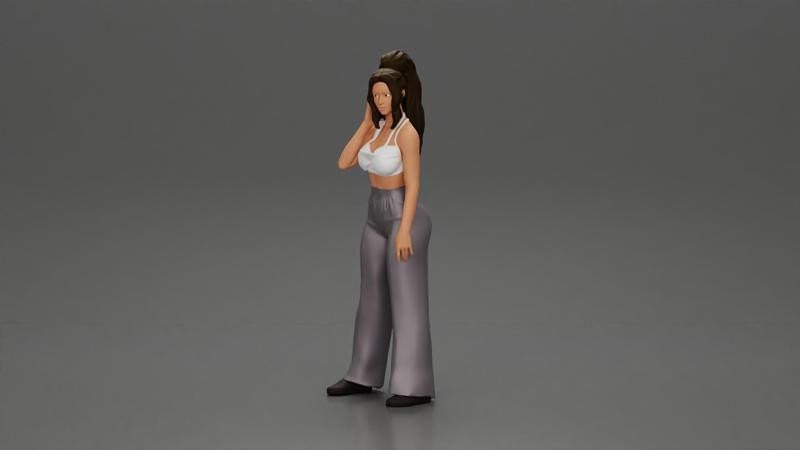 Stylish woman in a crop top and pants, standing thoughtfully