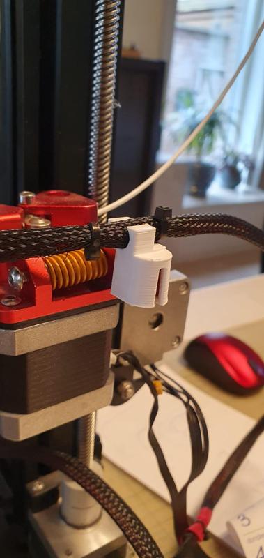 Cable holder to fix hotend cables on extruder. Improved model. Simple and good.