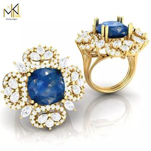 RING with deep blue color stone embraced by diamonds