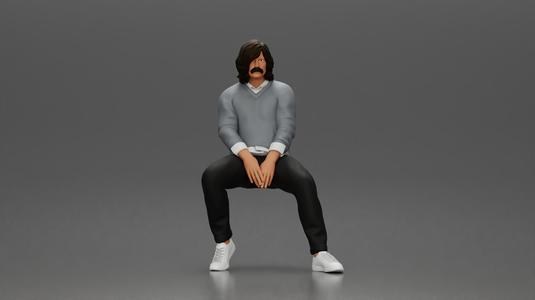 Man in Casual Sweater and Sneakers Sitting with Relaxed Posture