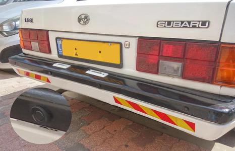 Parking sensor adapter for a tilted bumper