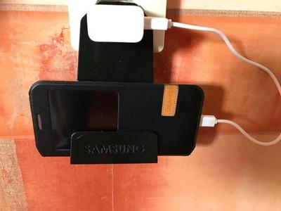 Phone charger holder for wall mounted socket