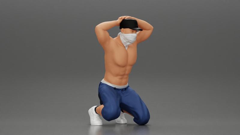 Gangster in mask and cap sitting putting his hands behind head about to be arrested