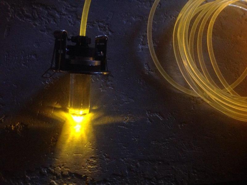 Optical fiber powered bathroom torch holder