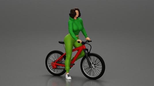 Young sexy sporty woman in pants and snickers short haired posing with bicycle
