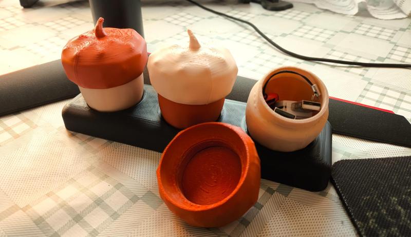 Acorn-shaped containers with threaded caps.