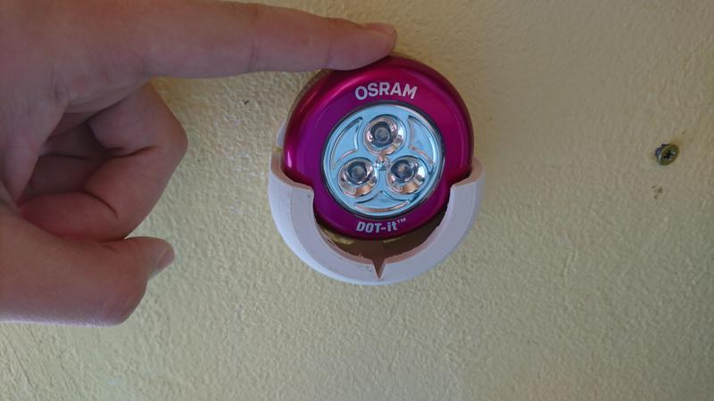 Holder for "DOT-it" battery lights