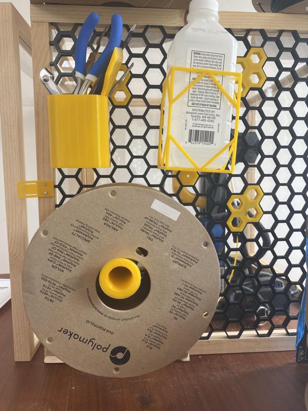 Spool holder for honeycomb storage wall