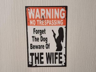 Warning danger woman wall sign.