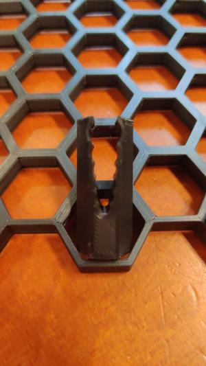 Cable clip for honeycomb storage wall