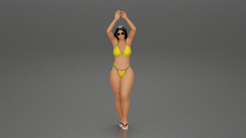 beautiful woman in a bikini with sunglasses standing with her arms raised up on the beach