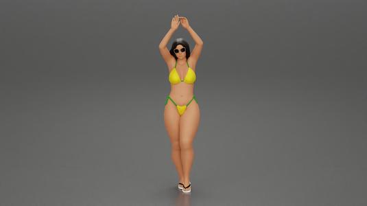 beautiful woman in a bikini with sunglasses standing with her arms raised up on the beach