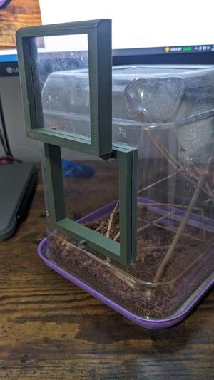 Latch to convert flat-sided plastic container into a terrarium