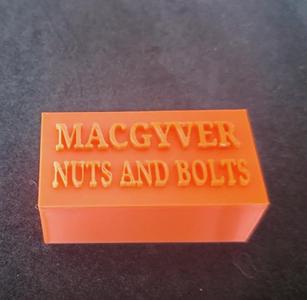 Box for storing small nuts and bolts, with the text MACGYVER NUTS AND BOLTS in the lid