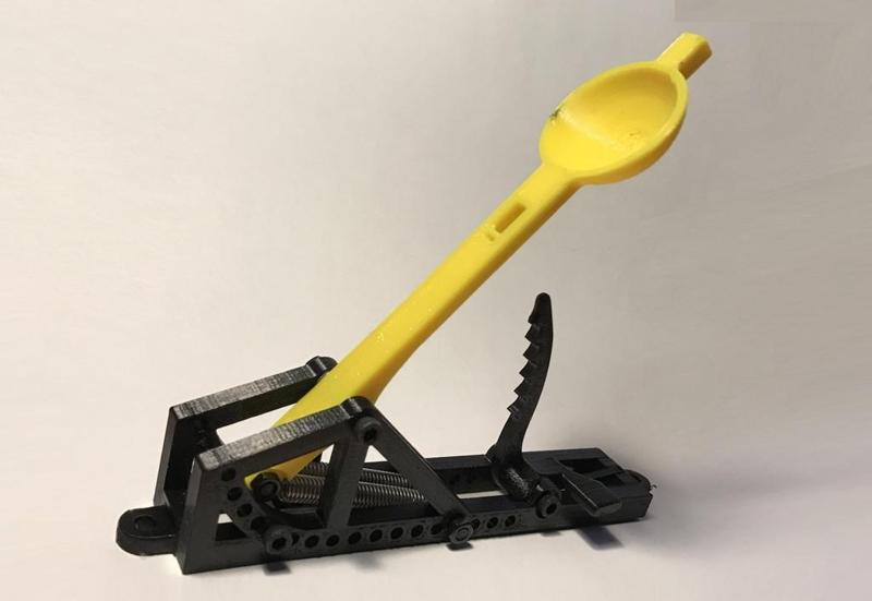 Spring loaded mini catapult