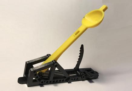 Spring loaded mini catapult