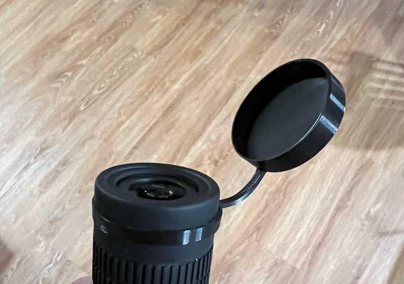 Flip-down cap for monocular or binoculars