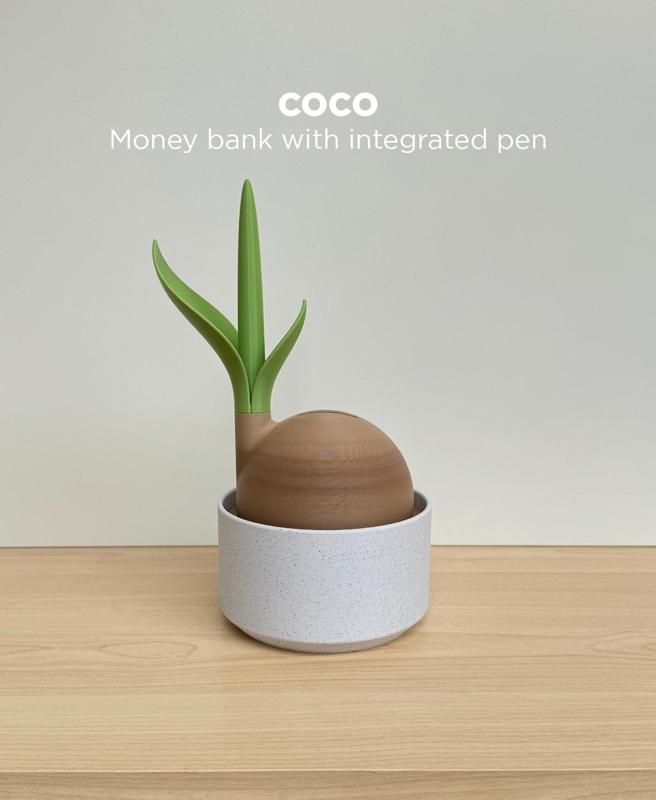 Coco, money bank with integrated pen.