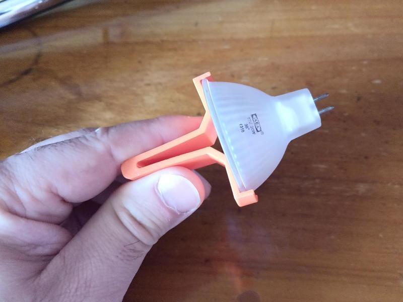 Clip for inserting spotlights into their housings