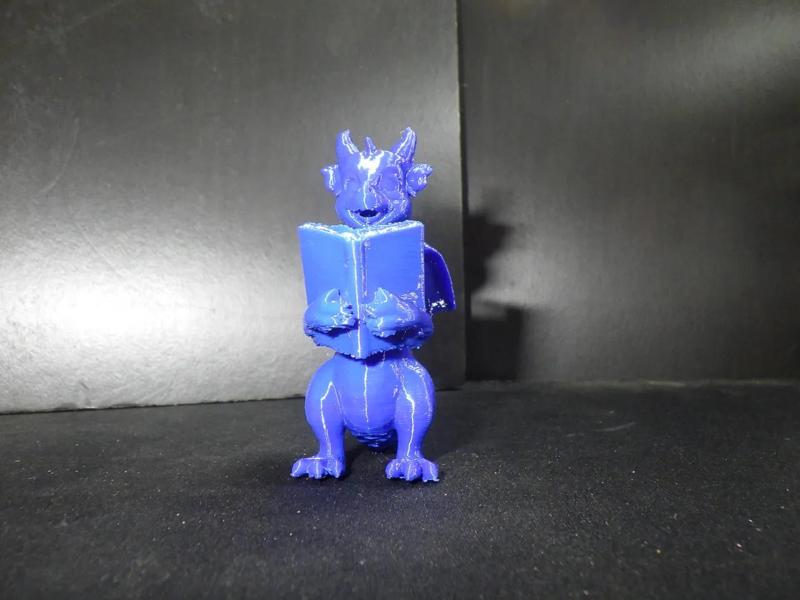 A dragon reading a book.   