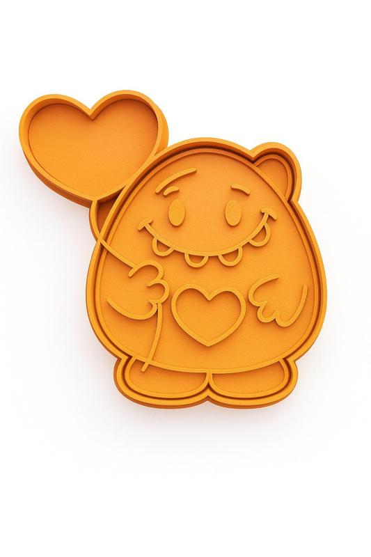 Cookie cutter shaped like a monster holding a balloon