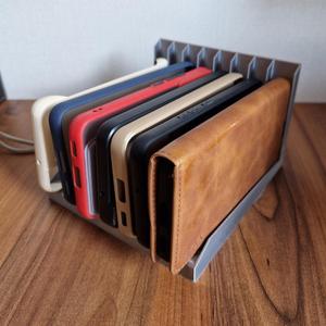 Multiple phone case holder for shelf