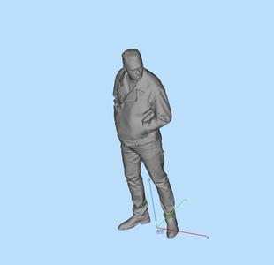 Miniature figure man standing and looking with his hands in his pockets
