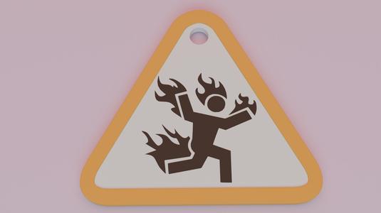 Keychain in the form of a sign Caution burning man