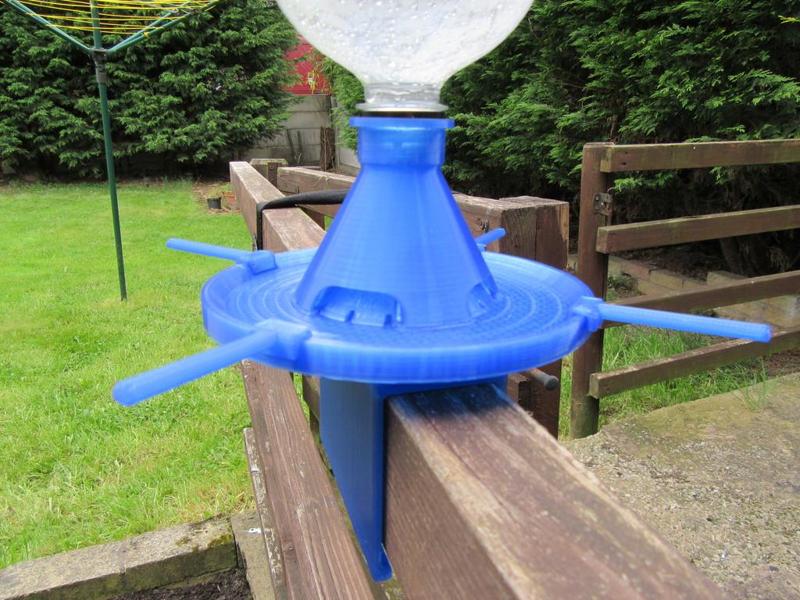 Pop bottle bird feeder for fence