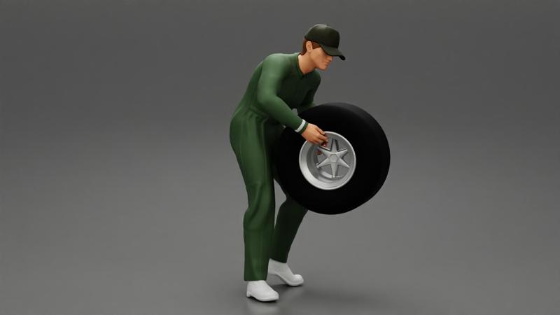 Auto mechanic walking and carrying tyre