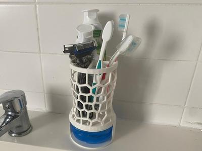 Bathroom organizer for toothbrushes and toothpaste