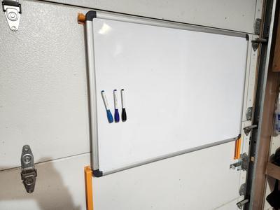 Sliding bracket to attach white board to garage door