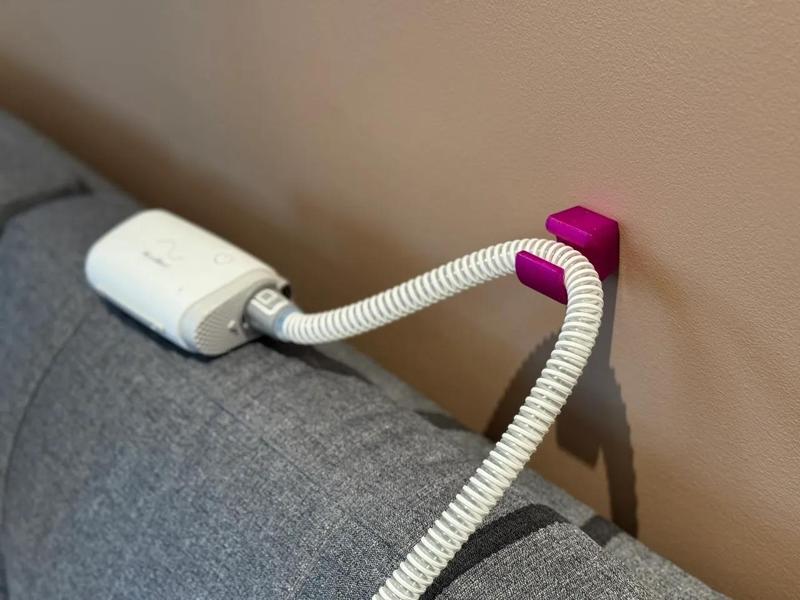 Magnetic CPAP tube guide and wall hook   