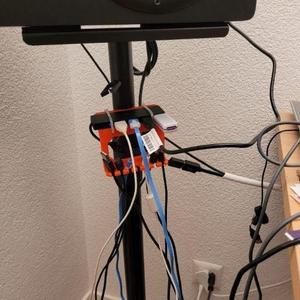 USB cable holder that fits onto a cylindrical post