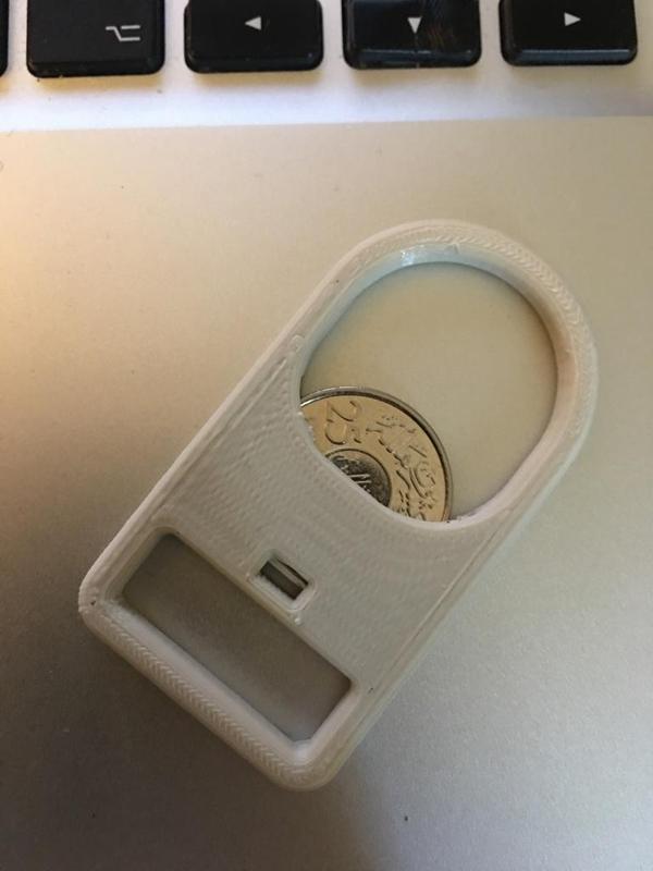 Bottle opener with .25 Saudi Riyal 
