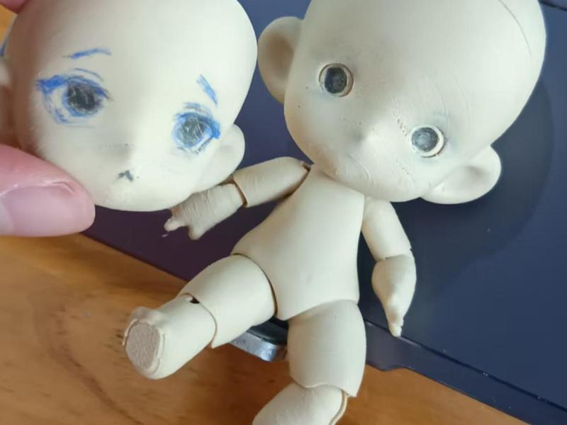 Can't sit, can't stand, big head small doll (assembly required)