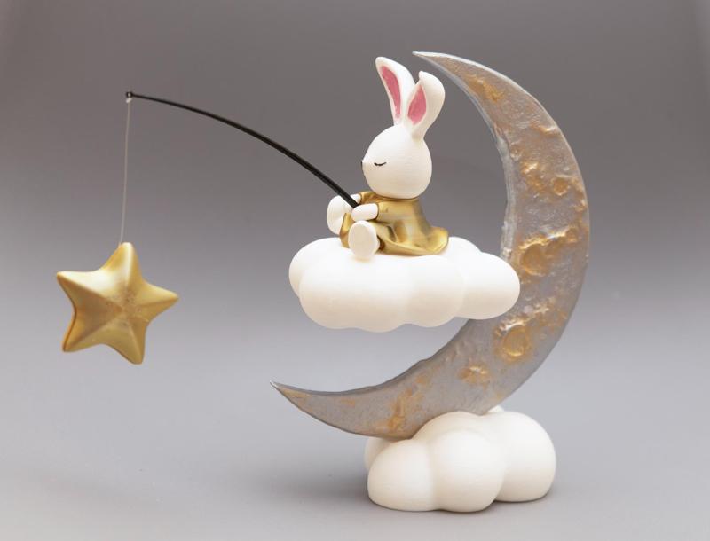 Cute figure of bunny sitting on the moon 