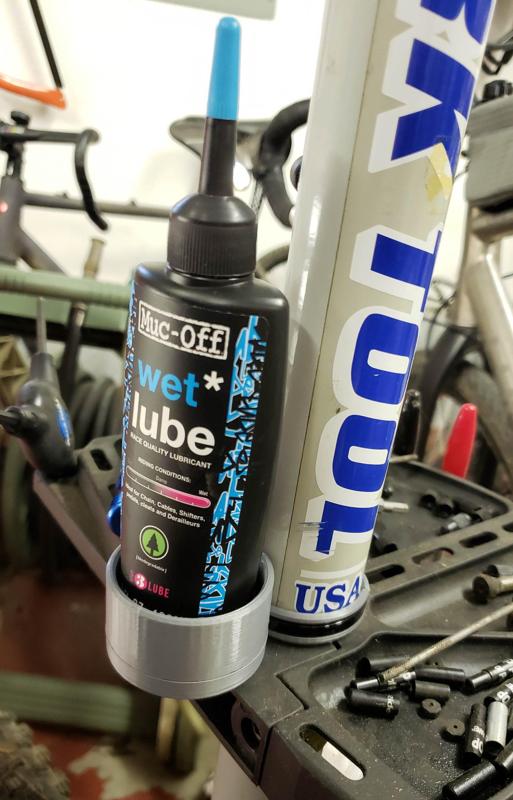 Bicycle repair stand lube bottle holder