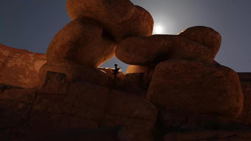 sword moon over rock formation at night