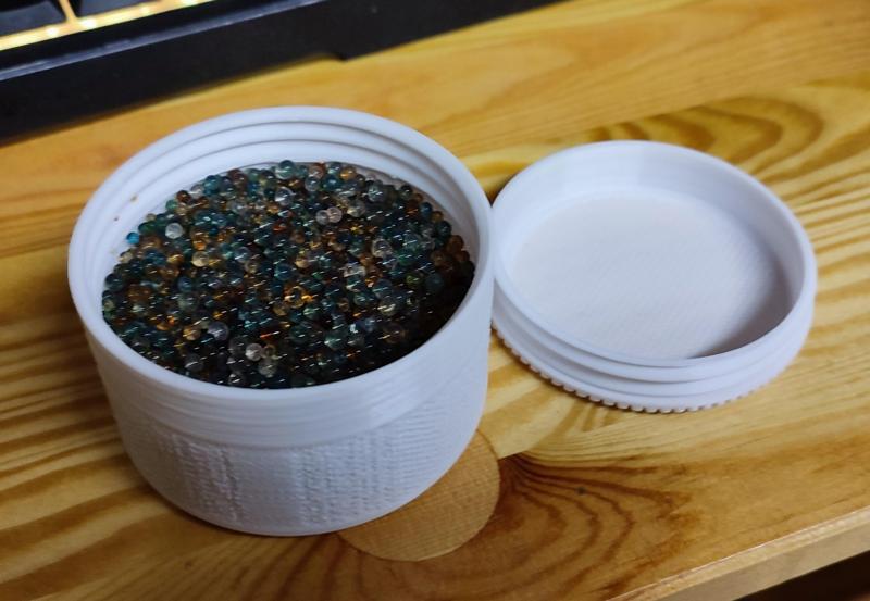 Porous silica gel container with screw on lid