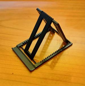Portable phone stand about the size of a credit card