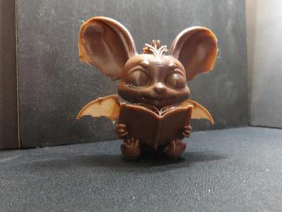 Bat reading a book.