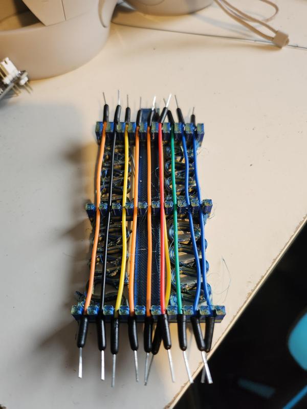 Spring tensioned jumper cable organiser