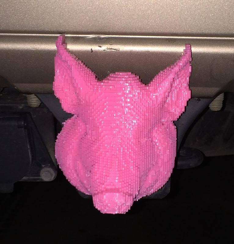 Pig on two inch trailer hitch cover