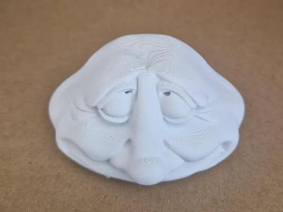 decorative stone sculpture with a face