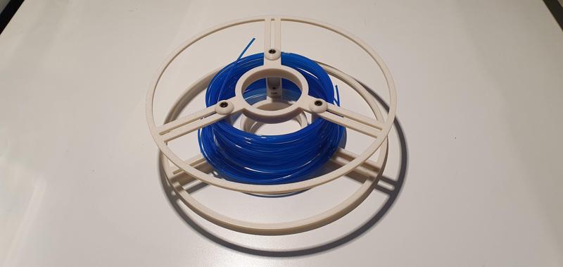 Reusable adjustable spool for spoolless filament